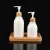 Import Plastic Round Pump Bottles with Bamboo Pump Top Cosmetic Bath Shower Shampoo Hair-Conditioner Liquid Storage container from China