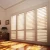 Import Custom white indoor wood window blinds folding plantation window shutters from China