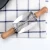Import Wholesale Stainless Steel Rolling Dough Cutter Making Croissant Wooden Handle Roller Knife For Croissant Bread from China