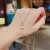 Import Fresh Style Titanium Steel Chain Black Crystal Bag Pendant Necklace Real Gold Plating Clear Crystal Handbag Necklace from China