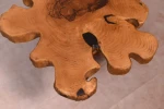 The table is artistically designed in the shape of a flower made of natural wood