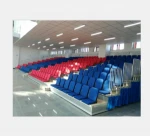 Retractable seating systems with soft fabric chairs for theatres, multipurpose venues