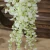 Import white wisteria artificial home decor wedding decoration artificial flowers vine hanging leaves purple wisteria flowers from China