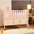 Import New Design pine The multifunctional pine baby bed Folding adjustable wooden baby crib from China