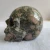 Import wholesale high quality natural amphibole rock deep color  crystal skulls for home decoration from China