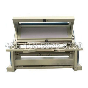 Textile fabric roll inspection finishing machine