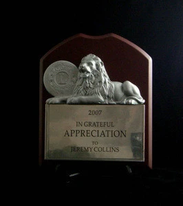 Wooden plaque with metal lion sculpture