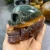 Import Wholesale natural hand carved crystal skull crystal art sculpture folk crafts colorful ocean jasper skull for decoration from China