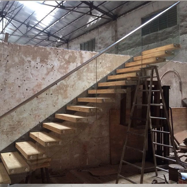 Glass clamp floating stairs with wooden tread and frameless glass railings