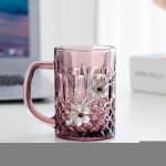Wholesale especial transparent glass water cups handle glass tea cups with flower embossed