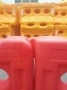 Durable red and yellow plastic traffic barrier for roadway safety