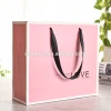 Wholesale custom pink gift shopping packaging paper bag with ribbon handle