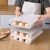 Import Creative automatic rolling egg cartridge cover can stack three rows of refrigerator egg cartons collision proof egg storage box from China