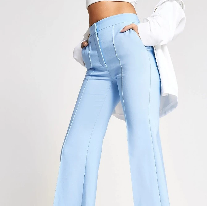Light blue structured flared trousers with side entry pockets and concealed zip fly fastening