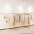Import Retail Gold Clothes Shop Display Wall Metal Hanging Rack Interior Design Furniture Fixture from China