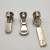 Import 3#,5#,8# Custom Logo Nickel-Free Metal Zipper Sliders and zipper Pullers from China