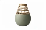 Moss green ceramic vase with square woven bamboo slats.