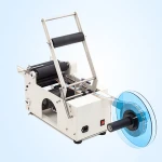 Handheld round bottle labeling machine/ Portable bottle labeling machine putting some stickers on the bottles
