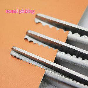 German tailor pinking wave blade scissors to cut cloth