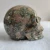Import wholesale high quality natural amphibole rock deep color  crystal skulls for home decoration from China