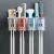Import Bathroom Storage Box Rack Wall Mount Automatic Toothpaste Dispenser Toothbrush Holder from China