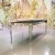 Import Stainless steel metal base black glass top gold dining table from China