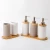 Import China Manufacturer White and Brown Porcelain 5 Piece Ceramic Bathroom Accessory Sets with Wooden Tap from China