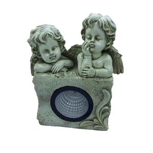 The new 2019 garden  two lovely angels are kneeling at the stone lamp with solar light