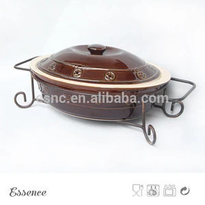 Stoneware color glazed bakeware with lid with star embossment and metal stand