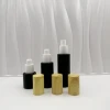 Wholesale luxury cosmetic fine mist black fronted glass bottle with plastic spray and wooden lid black fronted glass jar