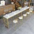 Import high end customized gold cocktail long bar table golden stainless steel marble top high counter bar table from China