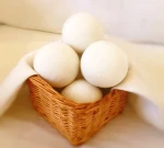 White eco washing machine felt ball Reduce appliance usage and electricity bills with dryer balls by shortening drying time