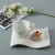 Import Creative cheap white coffee drinkware wave shaped ceramic porcelain latte espresso tea cups saucers sets from China