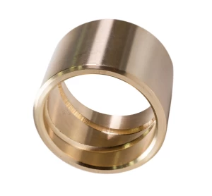 Self-lubricating cast bronze bushing with groove