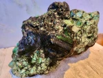 Rough and polished emeralds and alexandrites