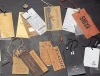 China supplier new design elastic string clothing hang tag with logo printing,metal logo tag