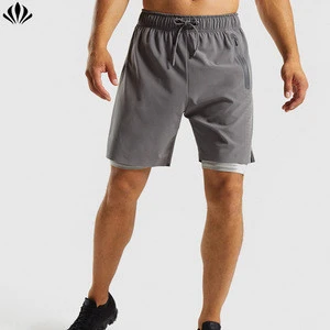Breathable perforated panel split hem training men shorts with compressive base layer