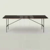 Dining table with powder coated steel base and center walnut swell pattern
