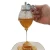 Import Honey Dispenser No Drip Glass Syrup Dispenser Glass Beautiful Honey Comb Shaped Honey Pot  Jar with Stand from China