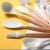 Import 11 piece marble silicone kitchen cooking tools wood handle silicone kitchen utensil with holder from China