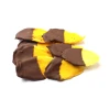 Dried mango fruit half coated with chocolate