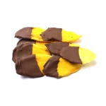 Dried mango fruit half coated with chocolate