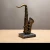 Import Antique Statue Saxophone Guitar Trumpet Sculpture Musical Instruments Orchestra Finishings Resin Sculpture Figurine Craft from China