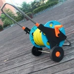 Self-retracting garden hose reel water