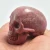 Import 2 Inch Natural Semi Precious Rhodonite Human Head Skull Carving Crafts For Decoration from China