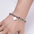 Import Women Simple Stainless Steel Trendy Bracelet Silver Clover Leaf Crystal Pendant Elastic Charms Bracelet from China