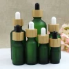 Wholesale high-quality 10ml 15ml 20ml 30ml 50ml 100ml frosted green essential oil glass dropper bottle with bamboo cap