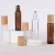 Import 5ml 10ml 15ml 0.5oz brown transparent frosted bamboo cover roll-on bottle wood grain cover for Essential oils from China