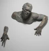climbing man wall sculpture in anique bronze colour