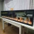 Import customized size cobbestonesfour screen video flame artificial electric fireplace with video crackling burning sound and logs from China